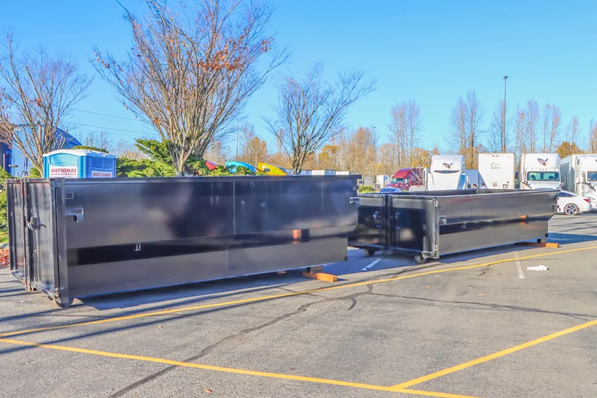 Professional dumpster rental service with roll-off container on residential driveway in Auburndale